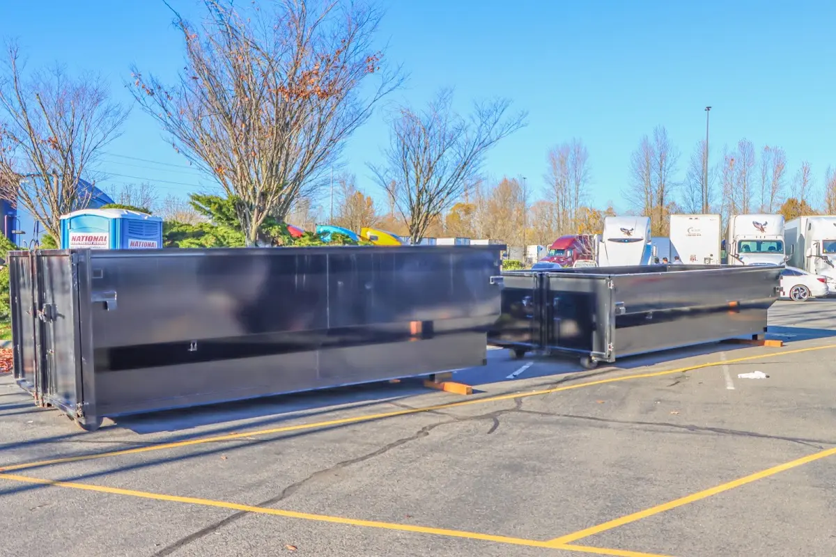 Professional dumpster rental service with roll-off container on residential driveway in Lynbrook